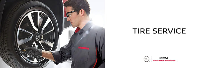 A banner for Tire Service at Icon Nissan of Chelmsford showing a mechanic inflating a tire.