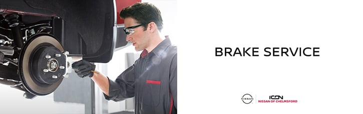 A banner for Brake Service at Icon Nissan of Chelmsford with a mechanic working on a car's brake rotor.