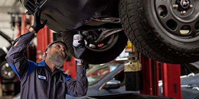 Mecánico trabajando debajo del coche.