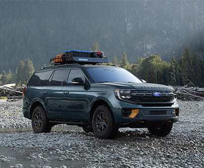 Two 2025 Ford Expedition parked on a rocky outcrop.