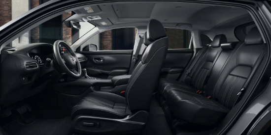 2027 Honda HR-V EX-L side view of the front and rear black leather seats and dashboard (Subcompact Crossover SUV).
