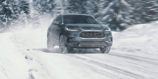 2027 Honda HR-V EX-L in Nordic Forest Pearl front view driving on a snowy road (Subcompact Crossover SUV).