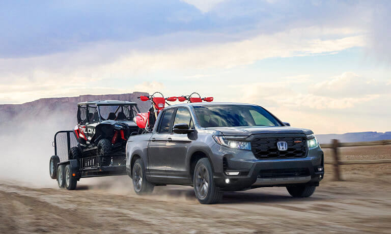 2025 Honda Ridgeline towing an ATV