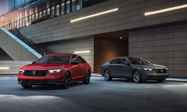 Two 2025 Honda Accords parked by modern building