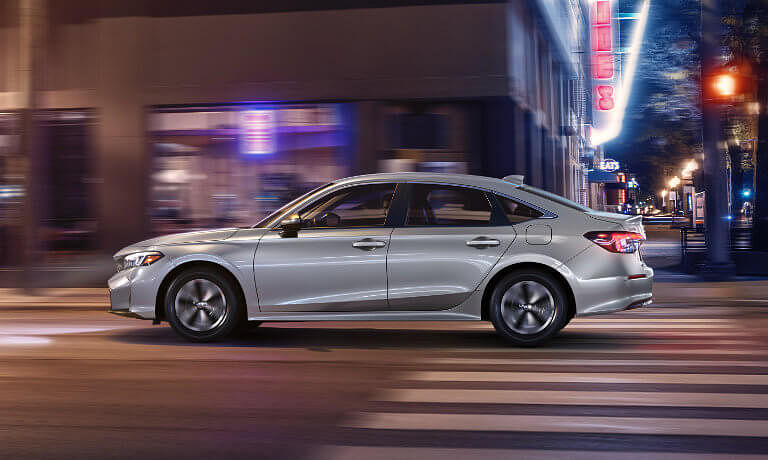 2025 Honda Civic driving fast in city at night