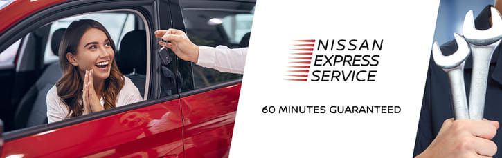 Happy customer sitting in a red car receiving her keys, alongside a mechanic holding wrenches for Nissan Express Service.