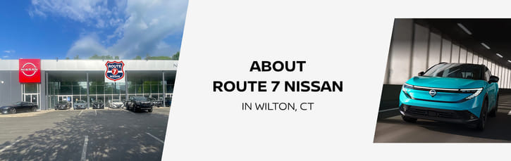 Route 7 Nissan dealership exterior in Wilton, CT alongside a teal Nissan Ariya driving on the road.