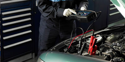 Mechanic performing battery check