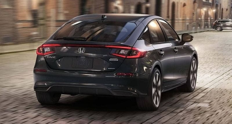 The 2025 Honda Civic Hatchback Sport Touring Hybrid in Meteorite Gray Metallic highlighting rear fastback attributes