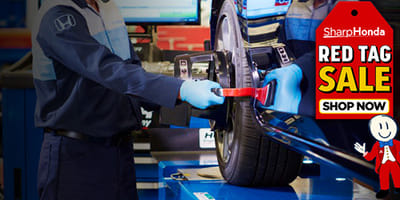 Mechanic working on wheel alignment