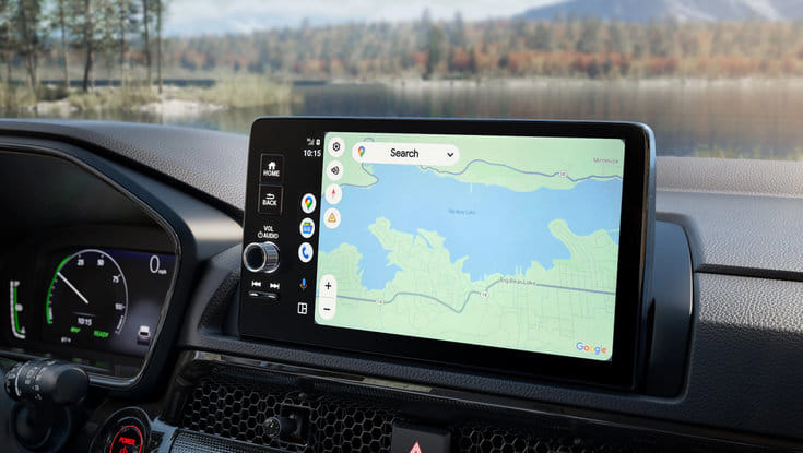 The car's infotainment screen displaying a Google Maps navigation view of a lake.