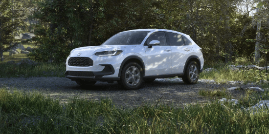 2027 Honda HR-V LX in Platinum White Pearl front view parked on a dirt path in a forest (Subcompact Crossover SUV).