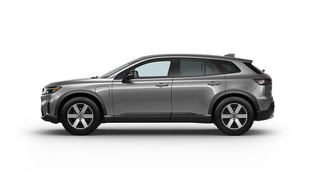 Driver side view of a silver Honda Prologue on a white background.