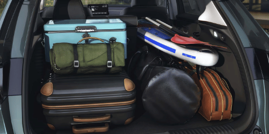 2027 Honda HR-V EX-L cargo area packed with luggage, a cooler, and a paddleboard (Subcompact Crossover SUV).