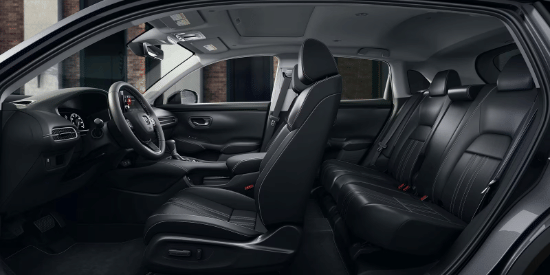 2027 Honda HR-V EX-L side view of the front and rear black leather seats and dashboard (Subcompact Crossover SUV).