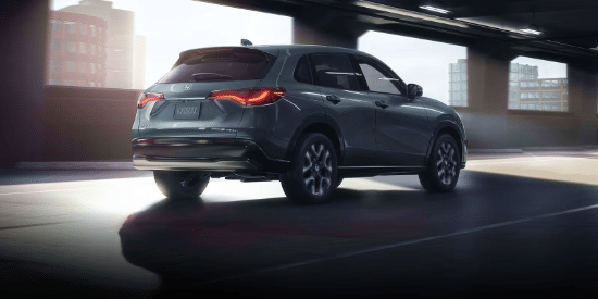2027 Honda HR-V EX-L in Nordic Forest Pearl three quarter rear view driving through a city tunnel (Subcompact Crossover SUV).