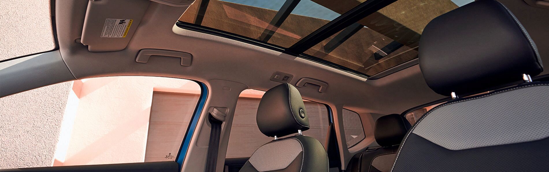 Interior view of a VW Taos highlighting the panoramic roof
