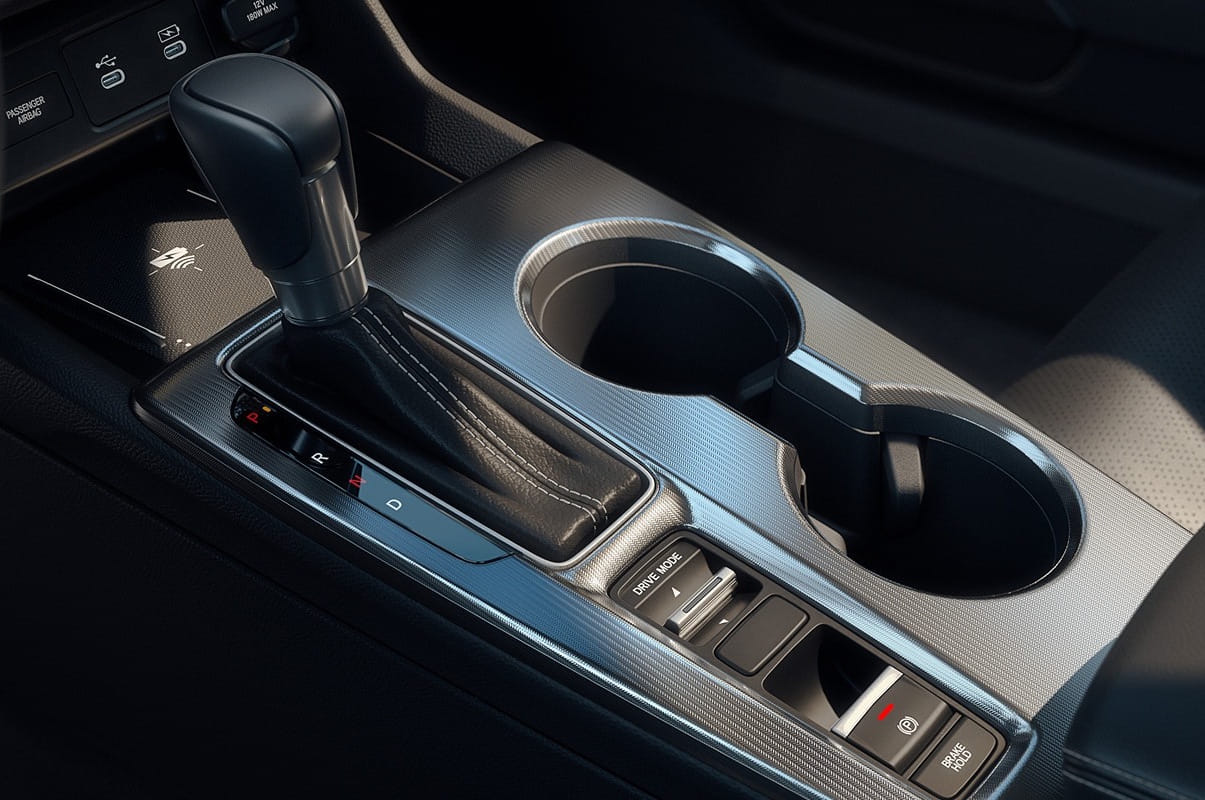 Close-up of a 2026 Honda Civic Sedan center console featuring a black gearshift, two cup holders, and buttons for drive modes. The design is modern and minimalist.