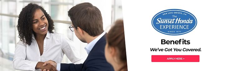 Woman smiling and shaking hand of another person