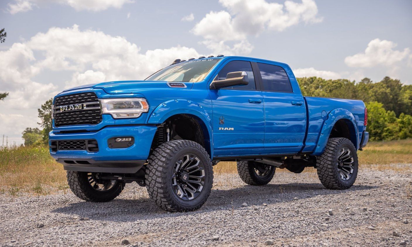 RAM 2500 Black Widow Edition parked on a gravel road, showcasing its rugged design and powerful stance.