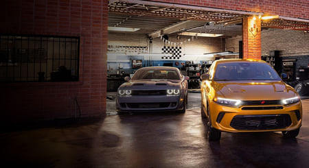 2025 yellow Dodge Hornet and 2025 gray Dodge Challenger standing in the garage.