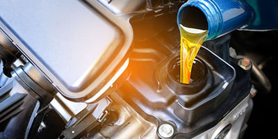 Mechanic pouring oil 