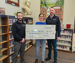 Tri City Cars presenting a donation check at the Somersworth Public Library.