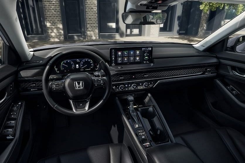 Interior view of a 2025 Honda Accord Hybrid showcasing a modern dashboard, touchscreen display, steering wheel, and leather seats.