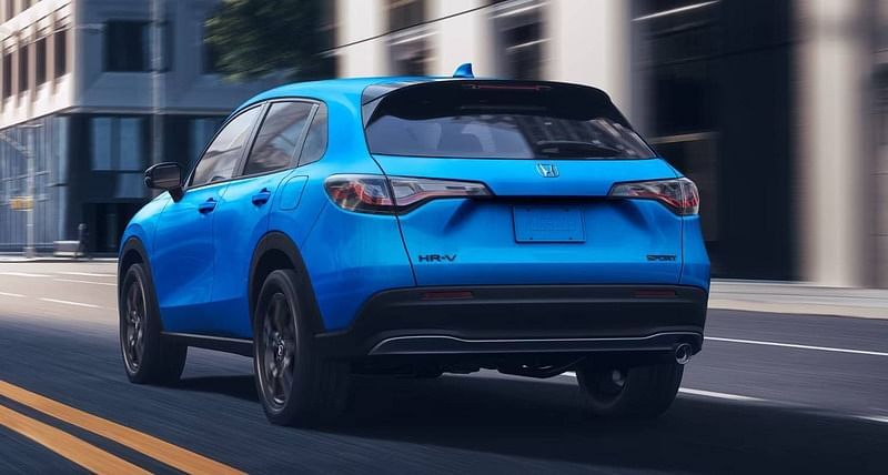 The 2026 HR-V in Boost Blue Pearl driving in a city