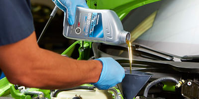 Mechanic changing oil in the car