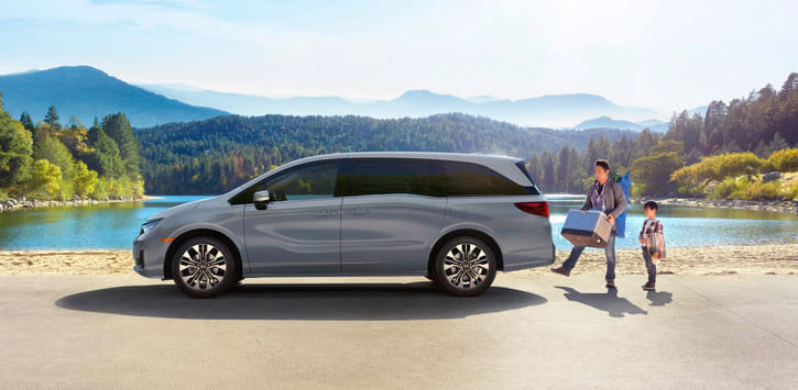 2026 Odyssey profile view, adult opening hands-free power tailgate.