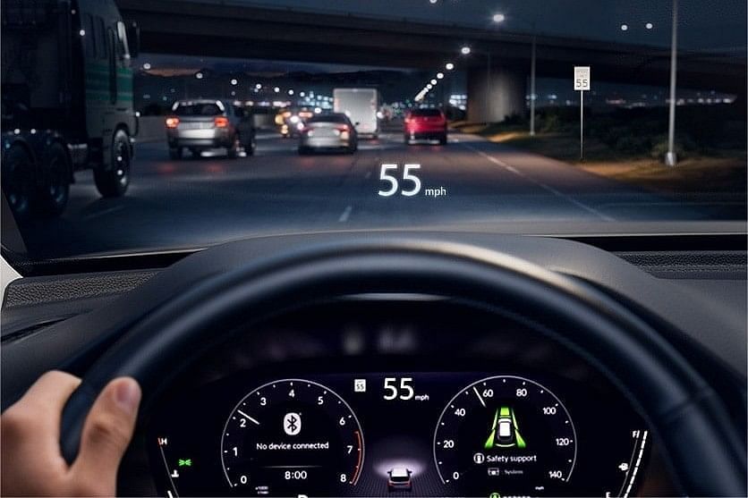 Dashboard view of a 2025 Honda Pilot at night showing speedometer reading 55 mph and heads-up display with speed information and safety features.